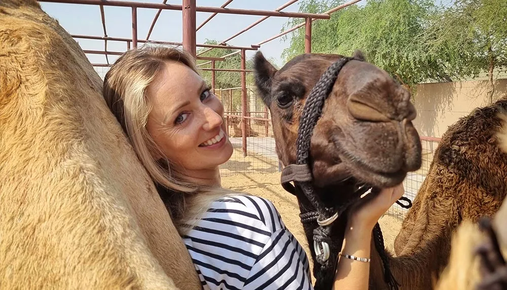 girl with camels on camel farm