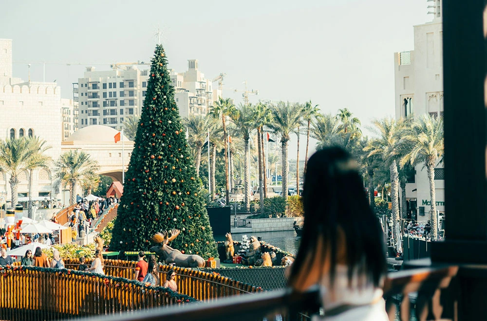 girl looking at christmas tree