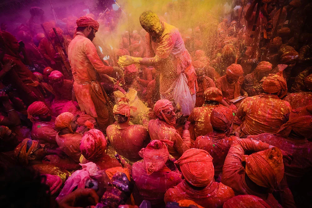 group of men covered in paint at holi festival